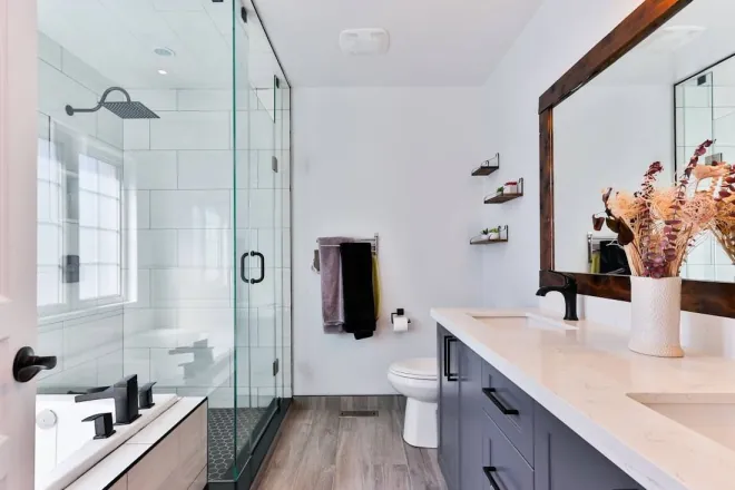 Design reference: bathroom with a glass-enclosed shower and rainfall head, a long vanity with black fixtures