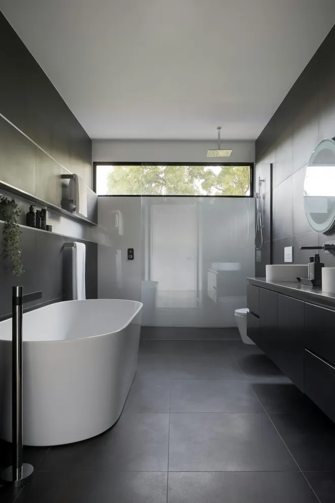 Bathroom remodeling inspiration: dark tiled bathroom with a freestanding tub